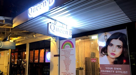 Queen B Skin and Beauty entrance in Melbourne, Victoria, AU, illuminated with bright signage and a stylist poster.