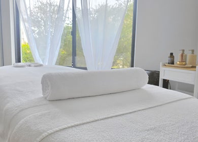 Relaxing massage room at The Siri Beauty & Eyelashes in Busselton, Western Australia, AU with cozy white linens.