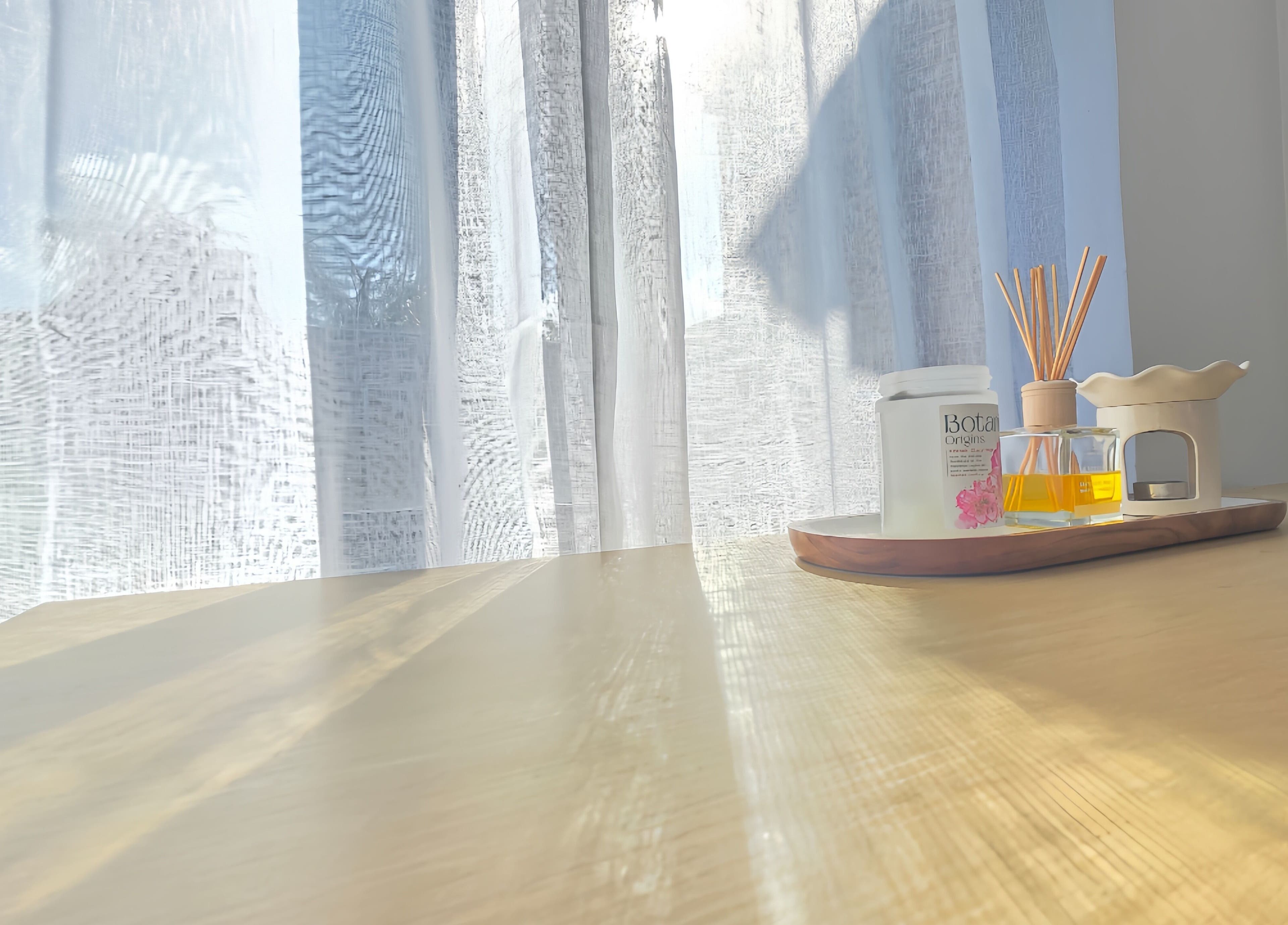 Scented oil and reed diffuser on wooden table at The Siri Beauty & Eyelashes in Busselton, Western Australia, AU.