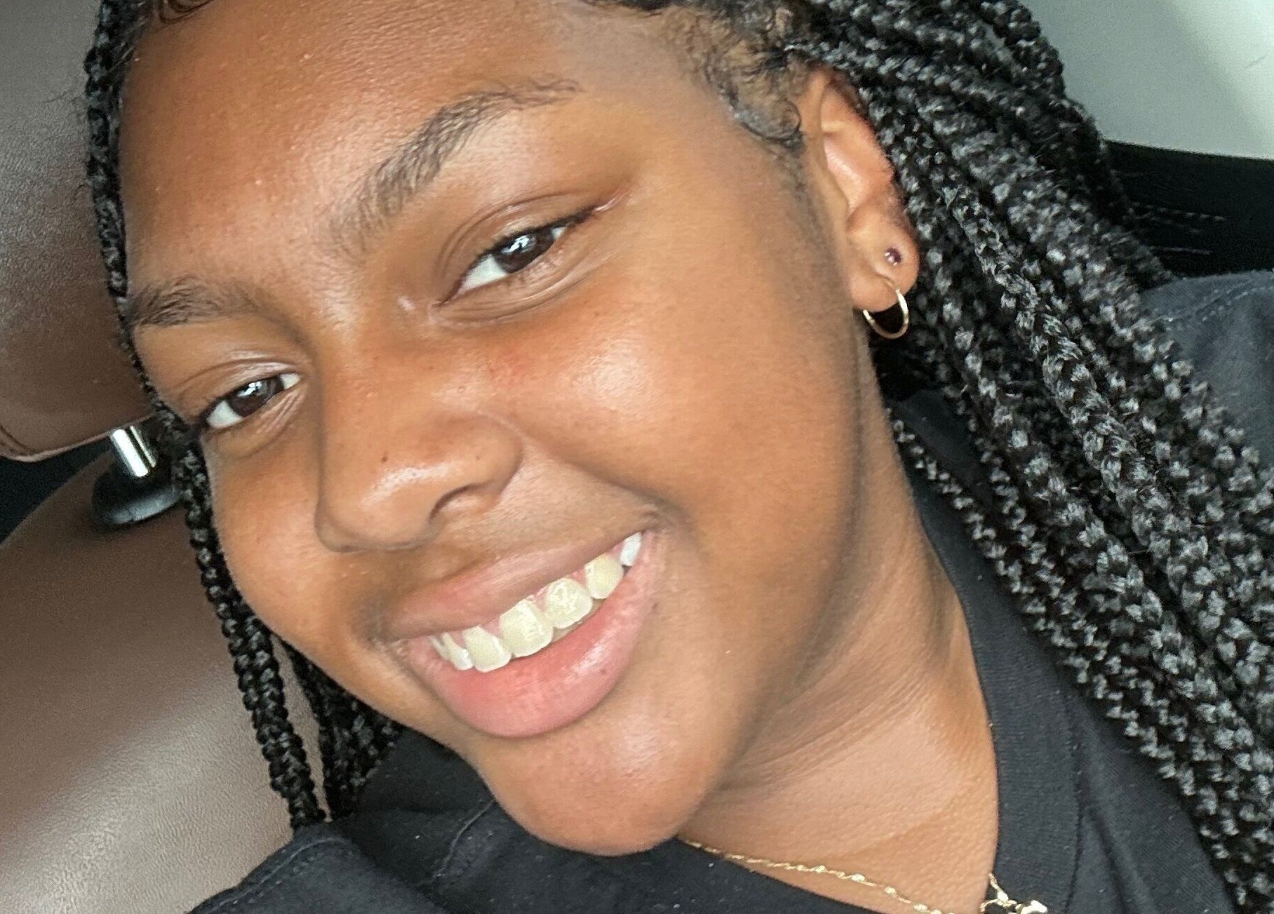 A smiling person showcasing a natural beauty style at I Am Natorious, Orange Park, Florida, US.