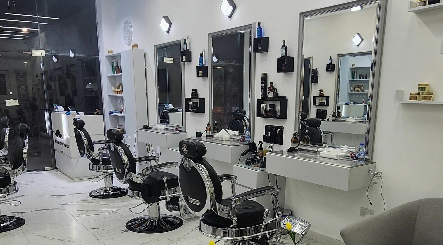 Sleek interior of Movember Gents Salon in Dubai, AE featuring modern barber chairs and styling stations.