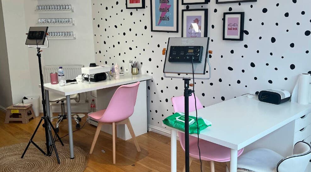 Stylish nail salon at Beauty Box Cardiff, Cardiff, Wales, GB with pink chairs and polka dot decor.