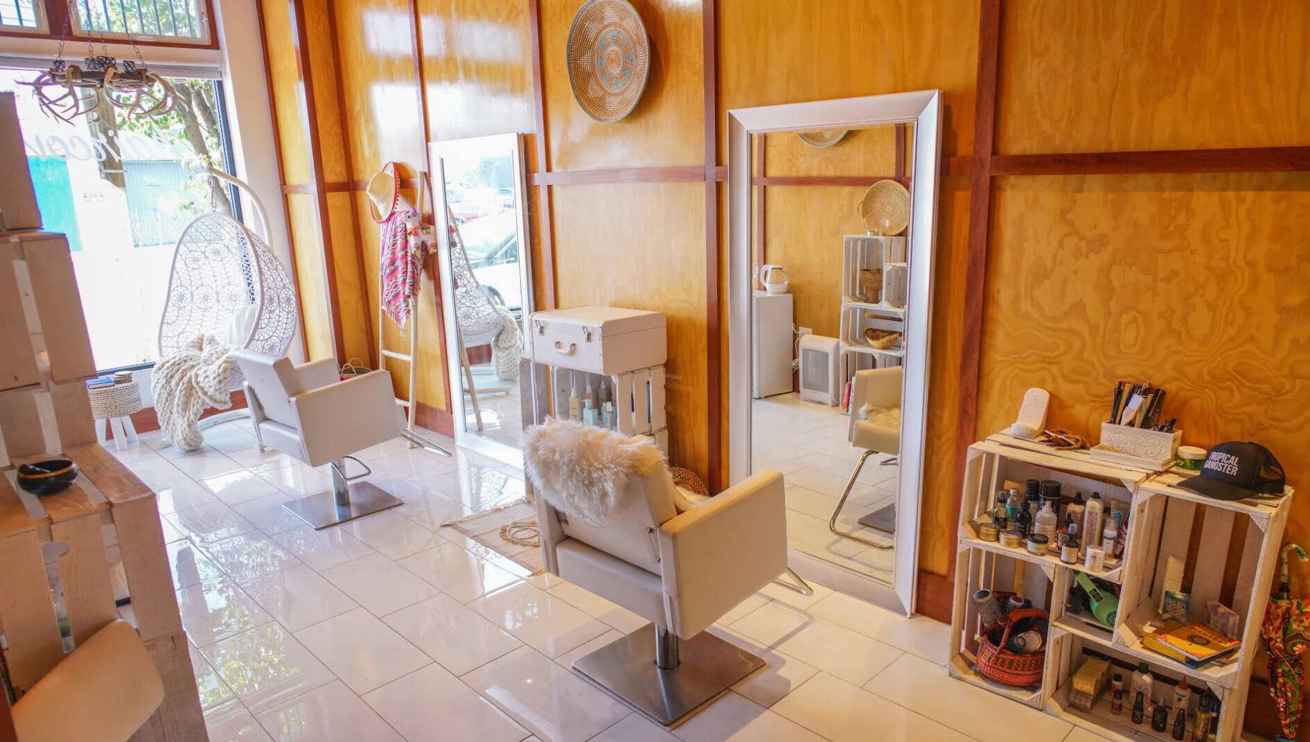 Modern salon interior at Haircoven, Los Angeles, California, US with sleek chairs and wooden decor.