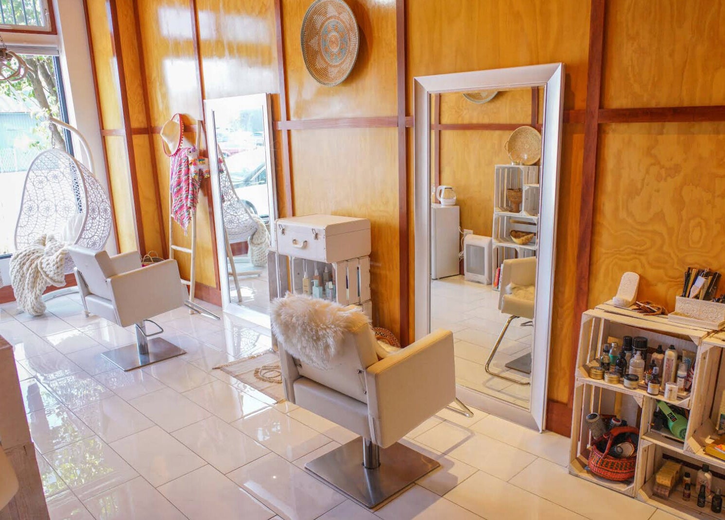 Modern salon interior at Haircoven, Los Angeles, California, US with sleek chairs and wooden decor.