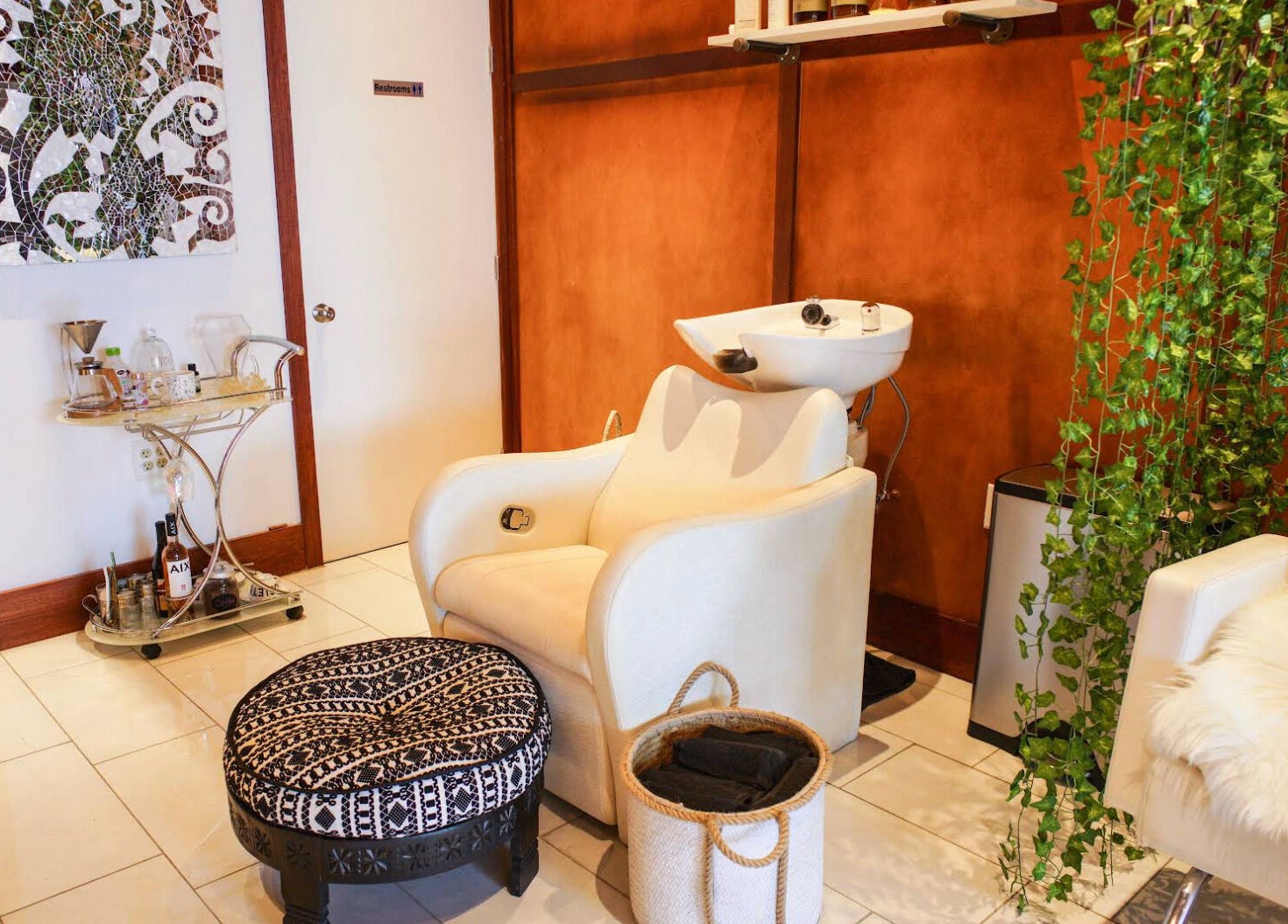 Elegant Haircoven interior with a wash station in Los Angeles, California, US, featuring plush seating.
