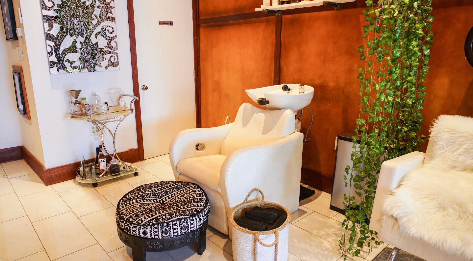Elegant Haircoven interior with a wash station in Los Angeles, California, US, featuring plush seating.