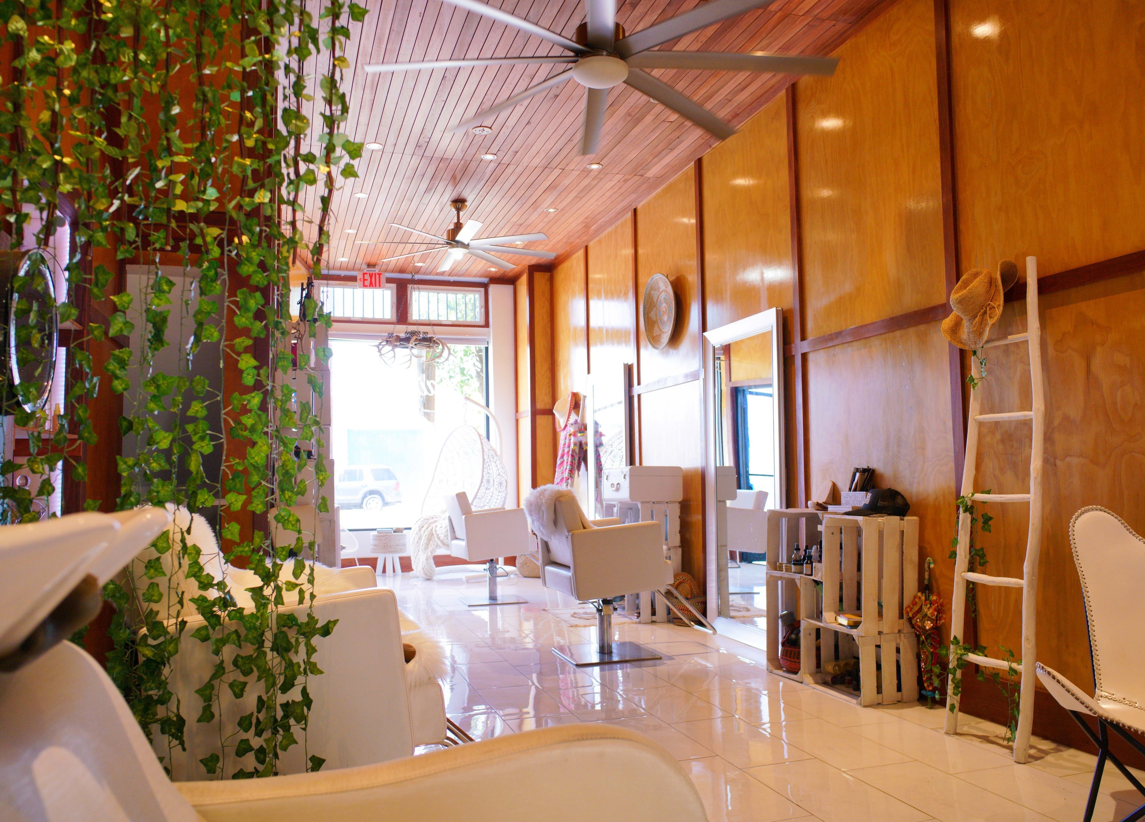 Relaxing interior of Haircoven in Los Angeles, California, US featuring lush green plants and stylish decor.