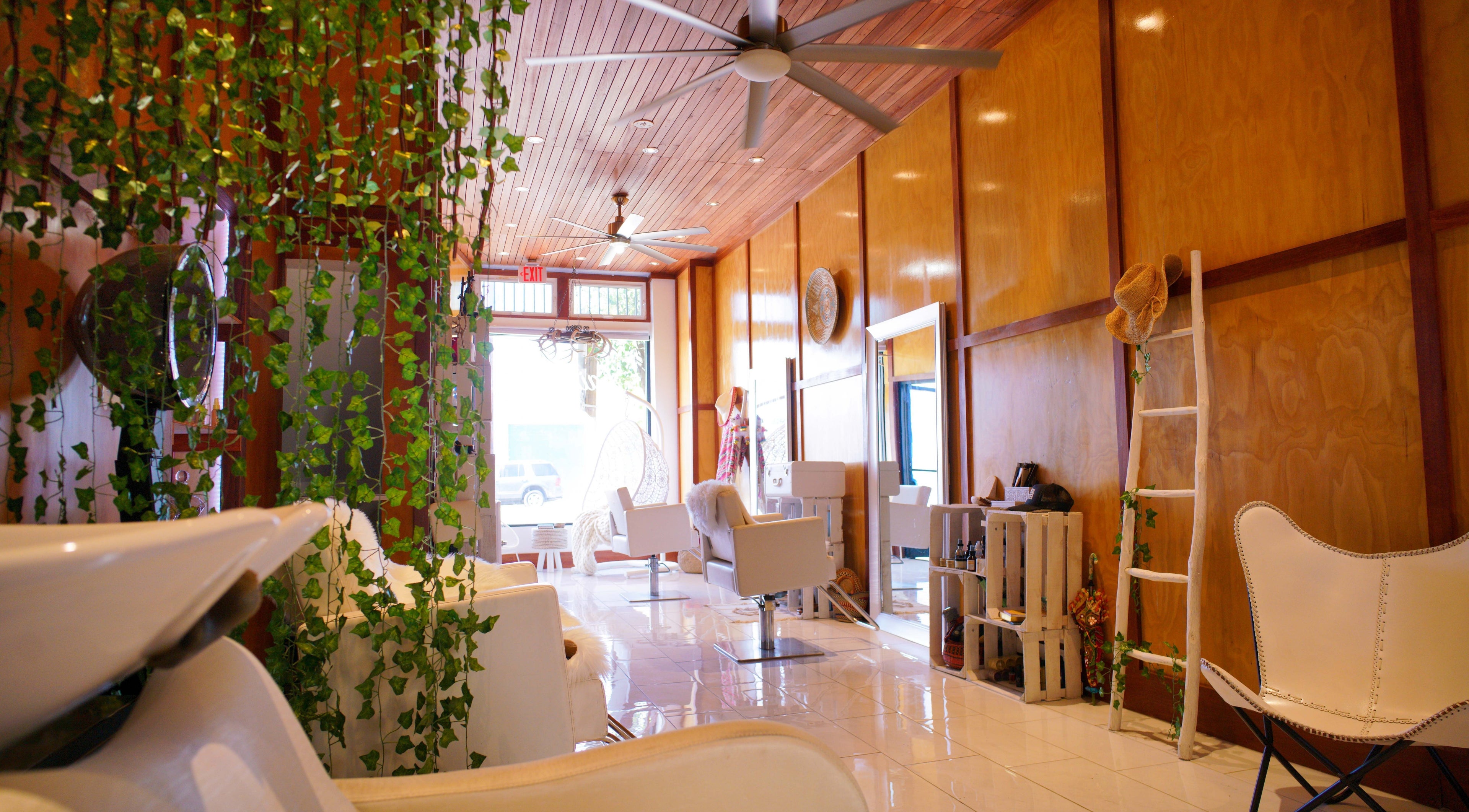 Relaxing interior of Haircoven in Los Angeles, California, US featuring lush green plants and stylish decor.