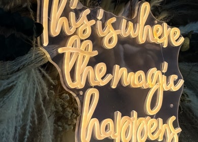 Illuminated sign 'This is where the magic happens' at Mi Amor Clinic Kilmallock, County Limerick, IE.