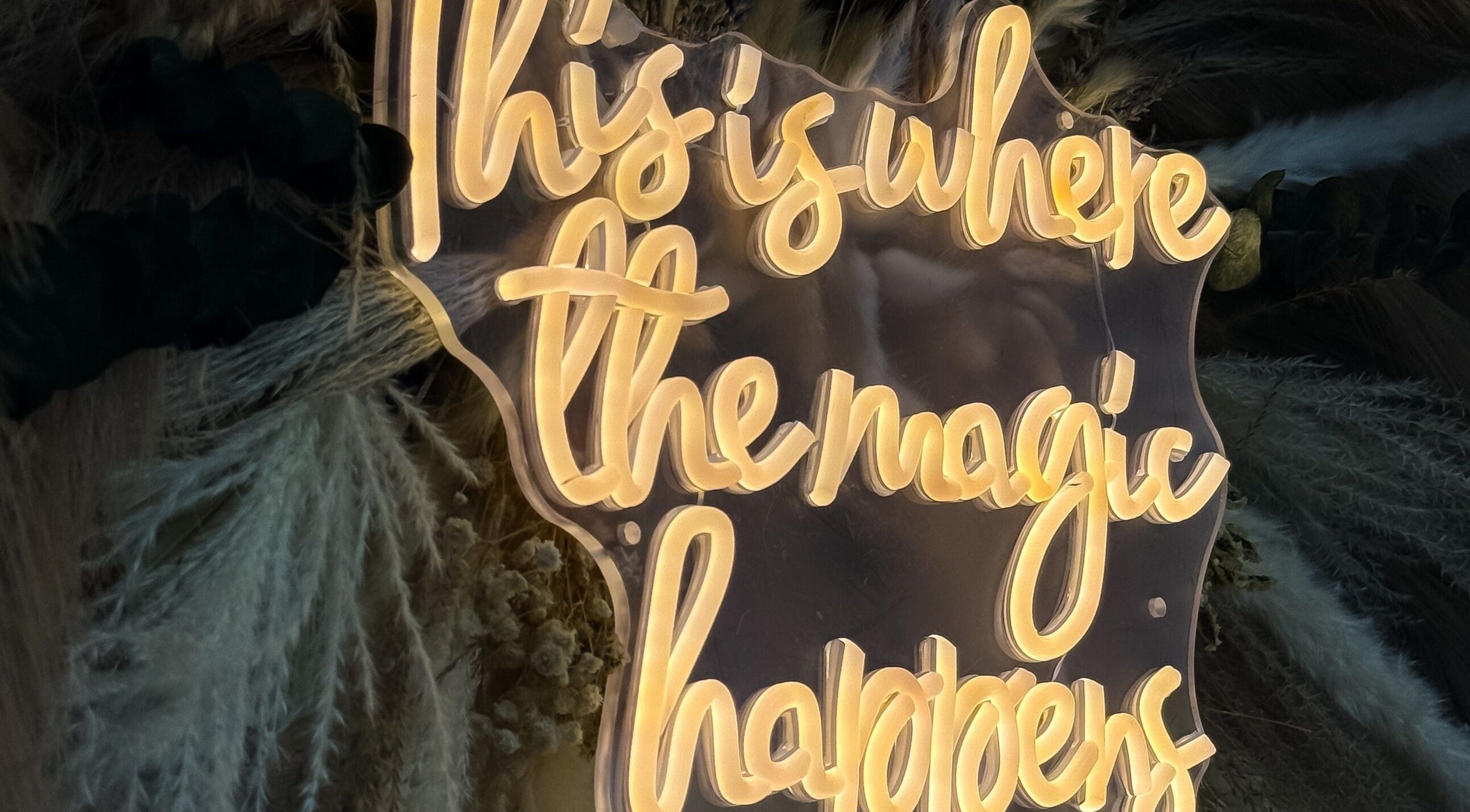 Illuminated sign 'This is where the magic happens' at Mi Amor Clinic Kilmallock, County Limerick, IE.