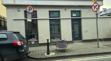 Street view of Mi Amor Clinic Kilmallock, County Limerick, IE, with modern exterior and sidewalk details.