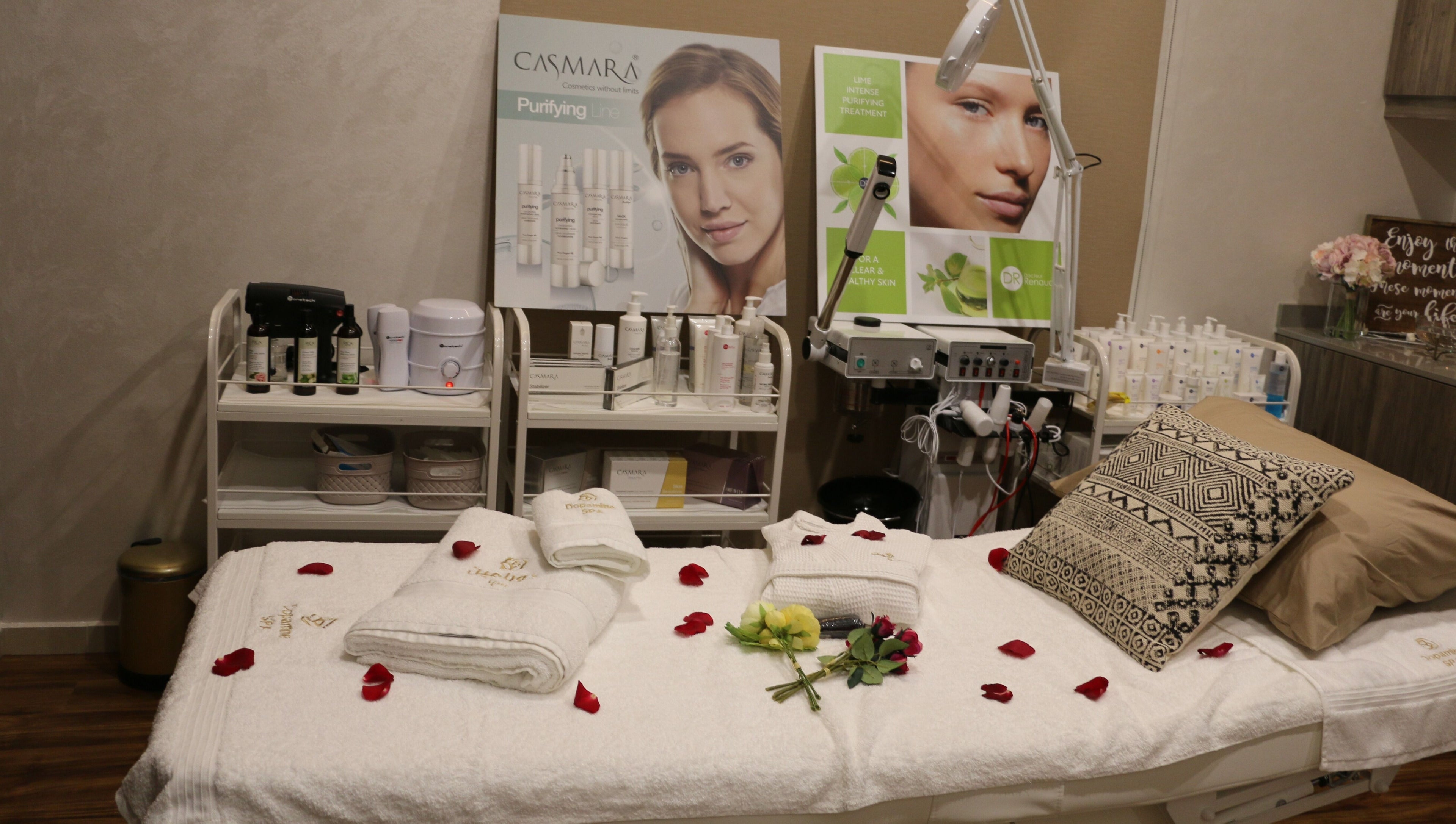 Luxurious spa room at Dopamine Spa, Ras al Khaimah, AE, with plush bed and beauty products.