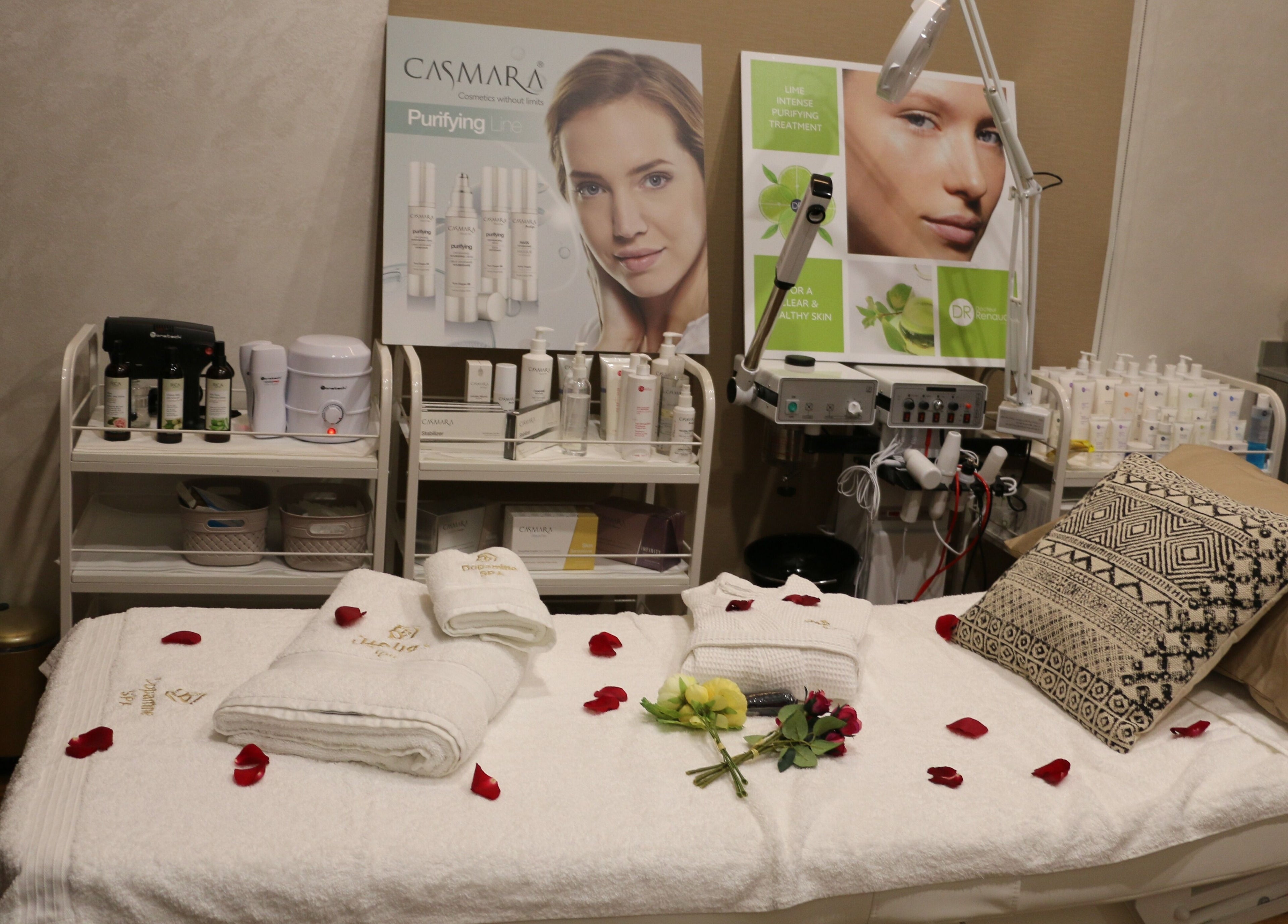 Luxurious spa room at Dopamine Spa, Ras al Khaimah, AE, with plush bed and beauty products.