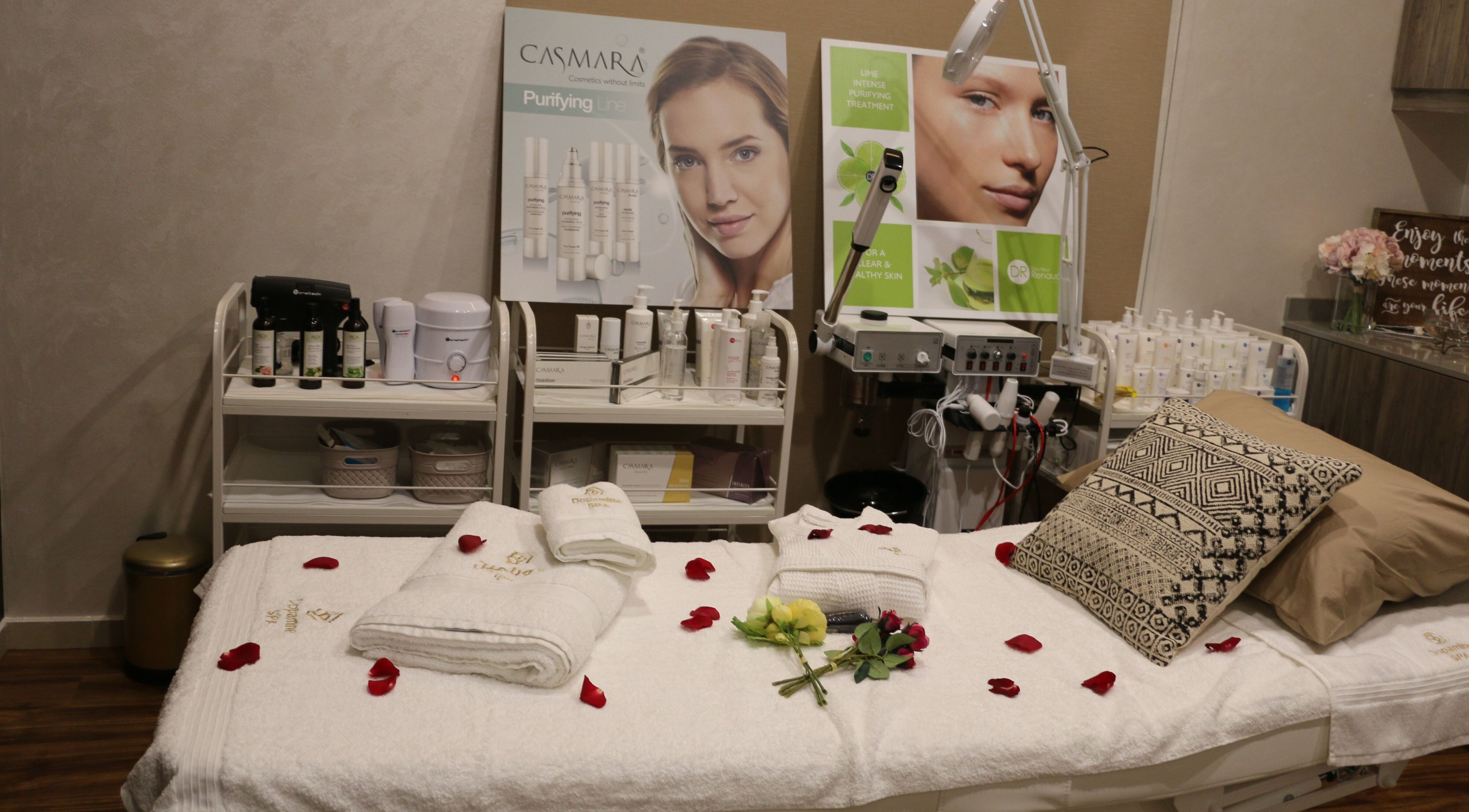 Luxurious spa room at Dopamine Spa, Ras al Khaimah, AE, with plush bed and beauty products.