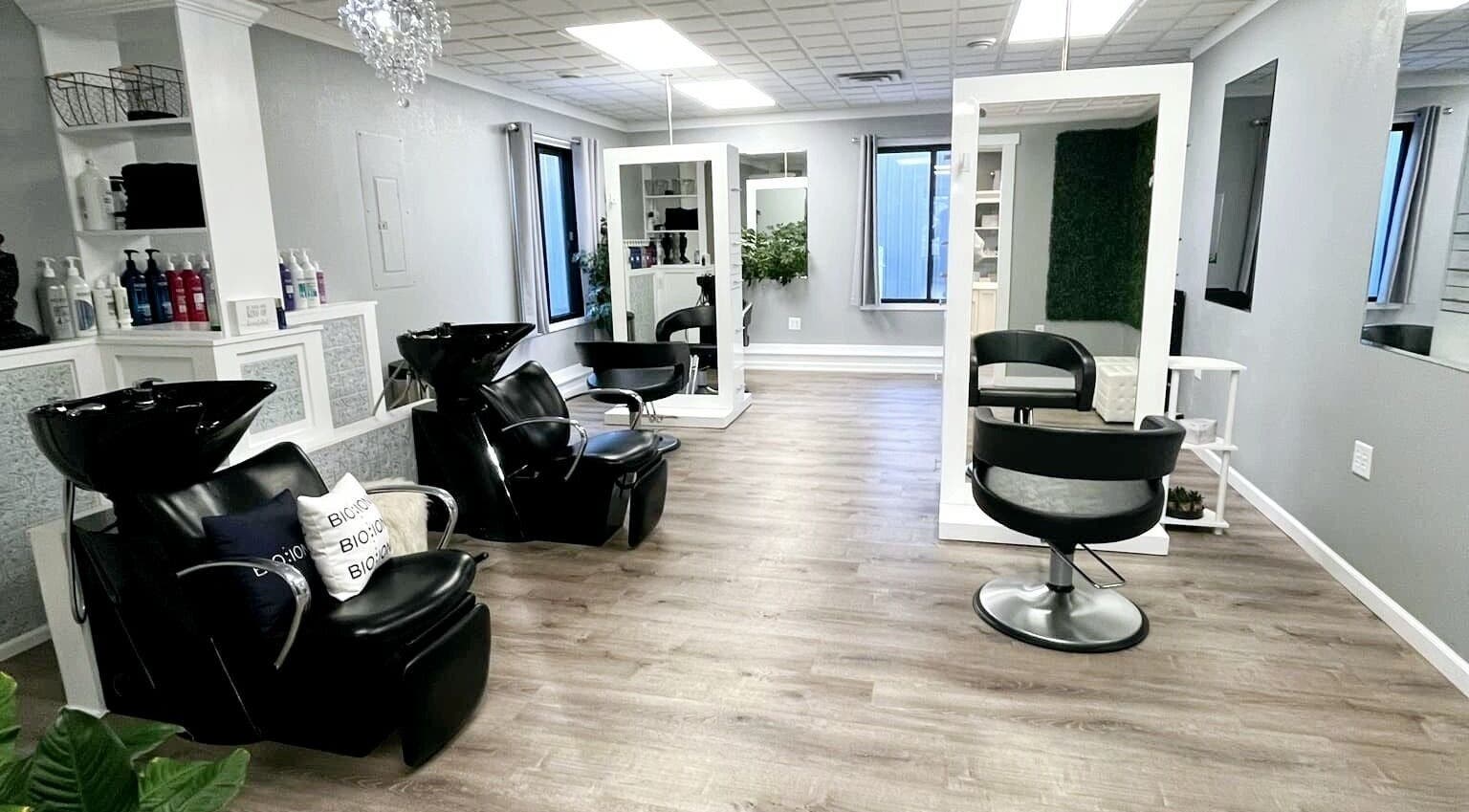 Interior of Shear Bliss salon in Tomah, Wisconsin, showcasing modern styling chairs and wash stations.