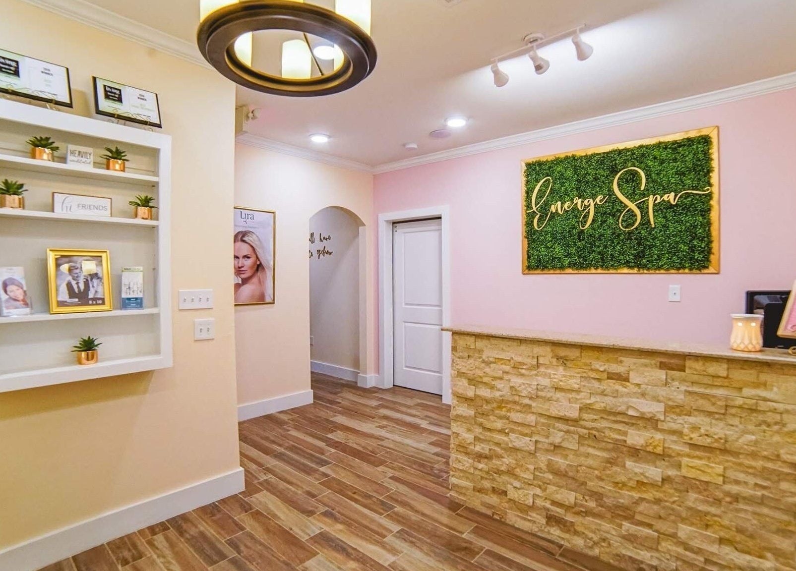 Energe Spa reception area with elegant decor in Cypress, Texas, US, featuring a green wall and cozy ambiance.