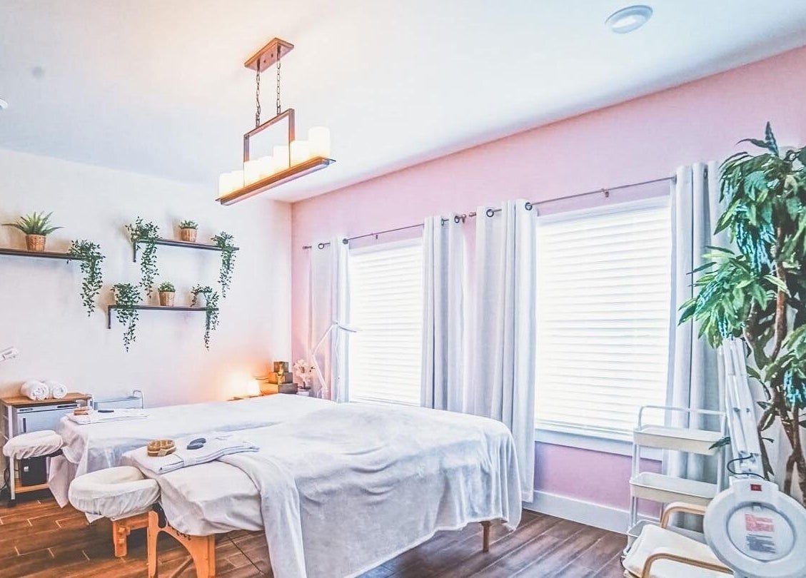 Tranquil treatment room at Energe Spa, Cypress, Texas, US with cozy decor and soft lighting.
