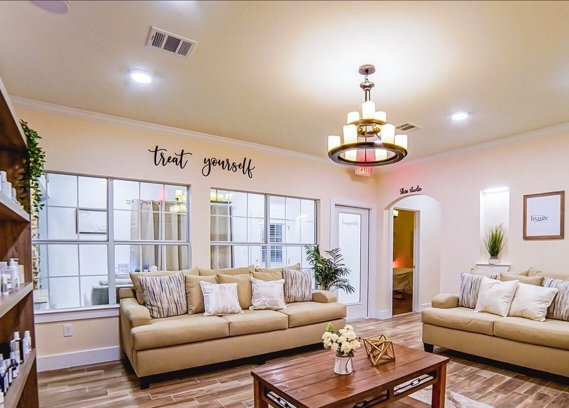 Relaxing lounge area at Energe Spa, Cypress, Texas, US, offering cozy seating and soothing ambiance.