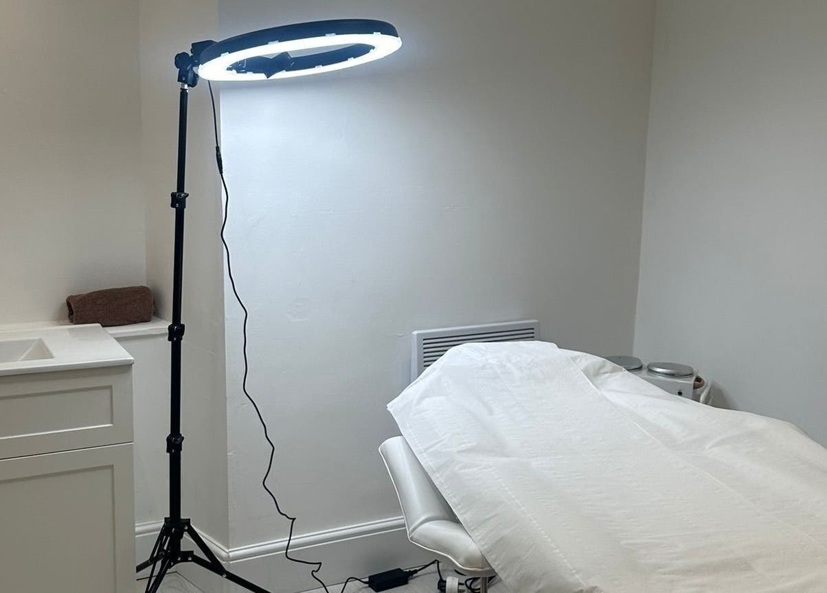 Treatment room at Rachael Louise & Co, Glasgow, Scotland, GB. Features a cozy bed and elegant lighting.