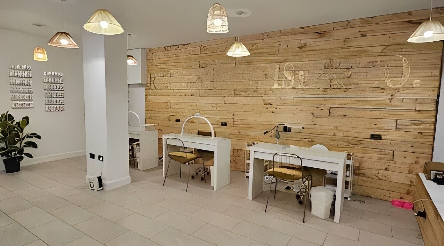 Nail stations at Rachael Louise & Co in Glasgow, Scotland, GB with natural wood accents and modern lighting.