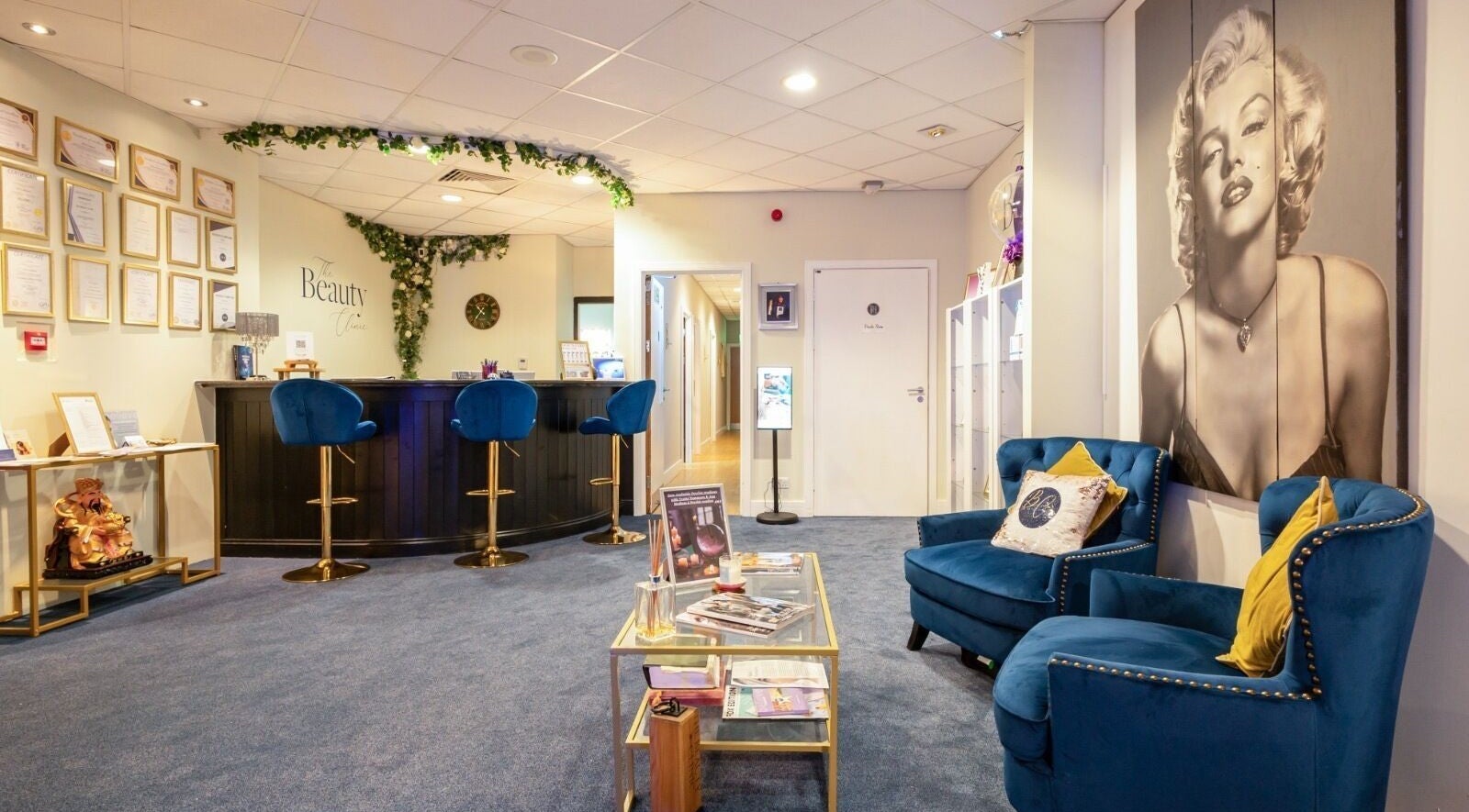Elegant reception area at The Beauty Clinic, Maidstone, England, GB with framed artwork and plush seating.