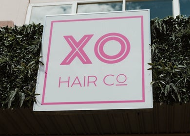 XO HAIR CO. sign with greenery at Melbourne, Victoria, AU beauty salon.