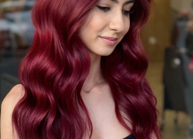 Elegant crimson waves hairstyle at XO HAIR CO., Melbourne, Victoria, AU, showcasing vibrant color and style.