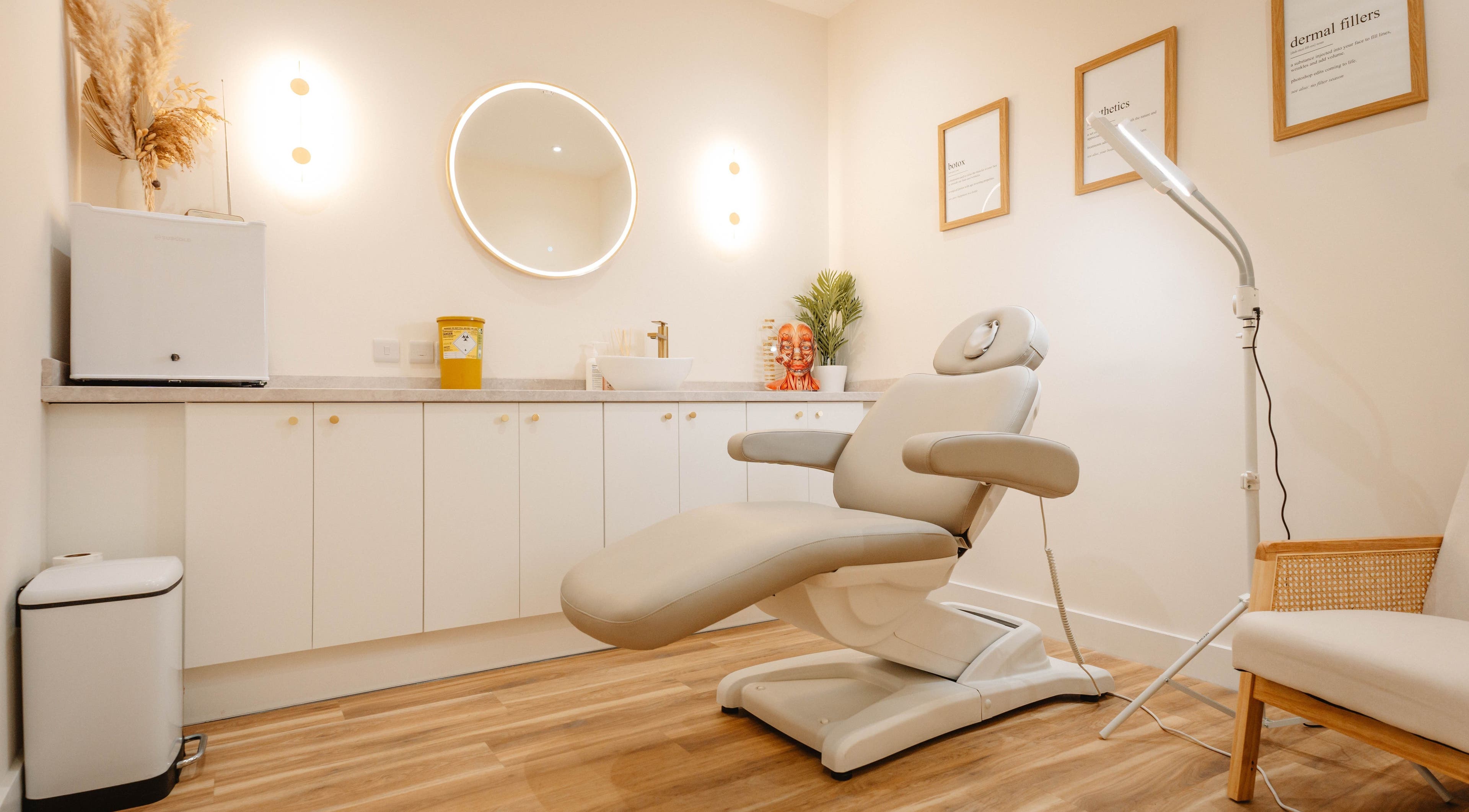 Freeda Clinic, England, GB features a serene treatment room with a plush adjustable chair and elegant decor.