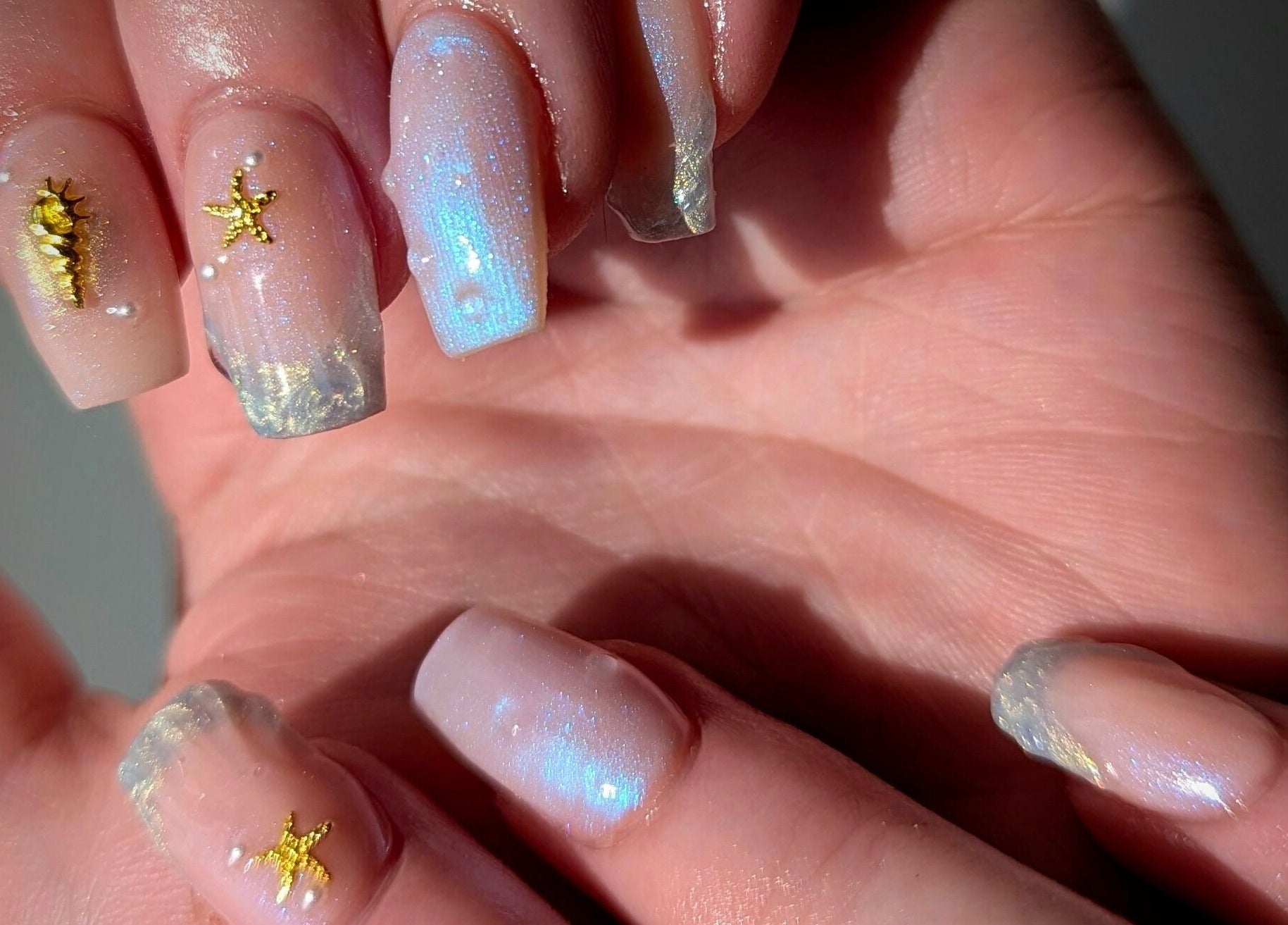 Opalescent manicure with seashell and starfish at Kathsklaws, Wolverhampton, England, GB.
