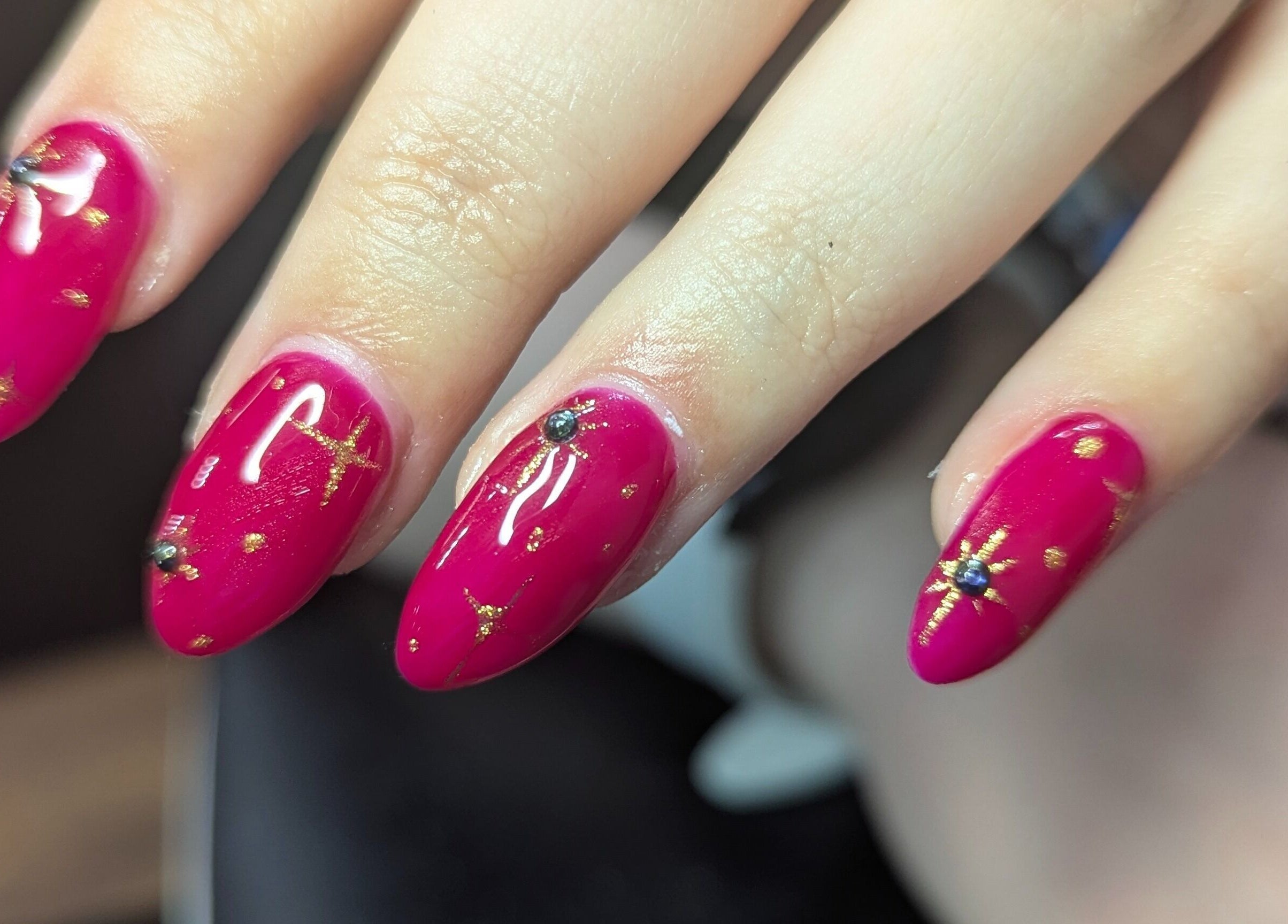 Elegant red nails with gold accents at Kathsklaws, Wolverhampton, England, GB.