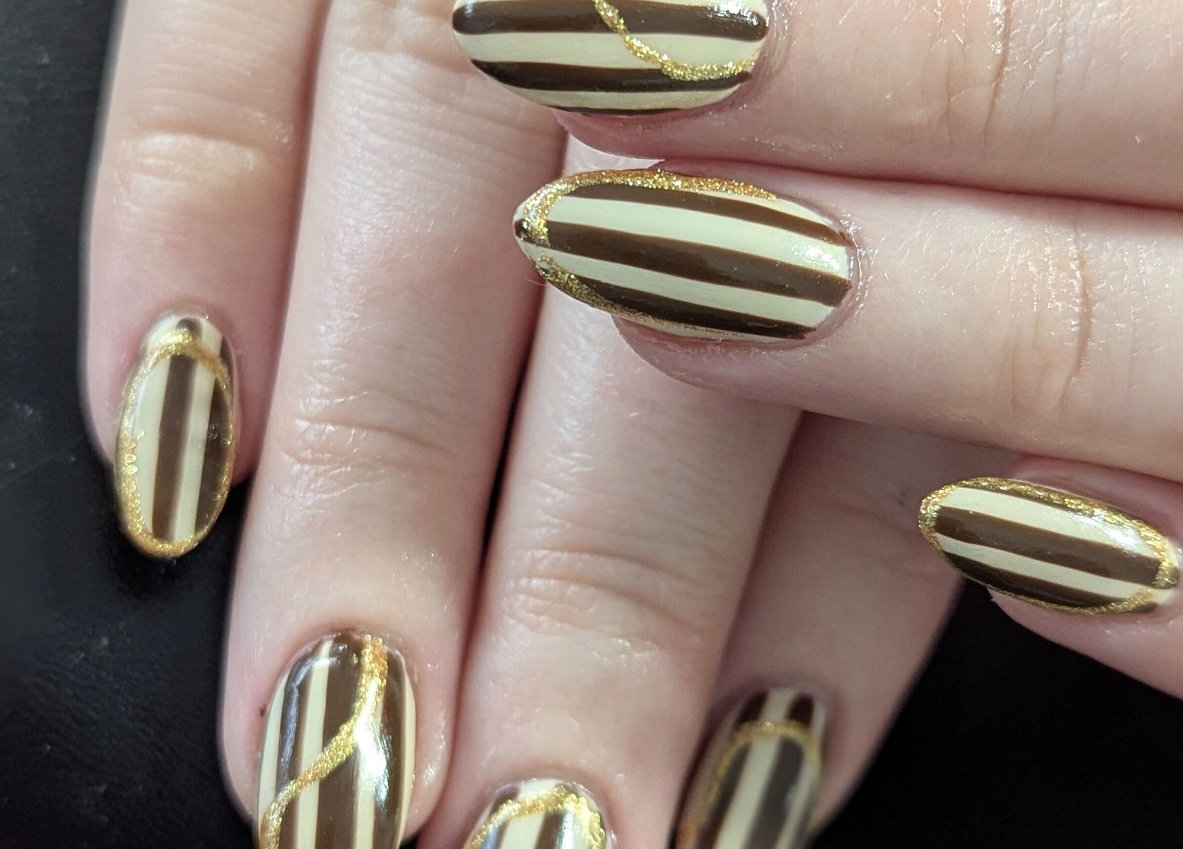 Stylish gold-accented nails at Kathsklaws, Wolverhampton, England, GB.