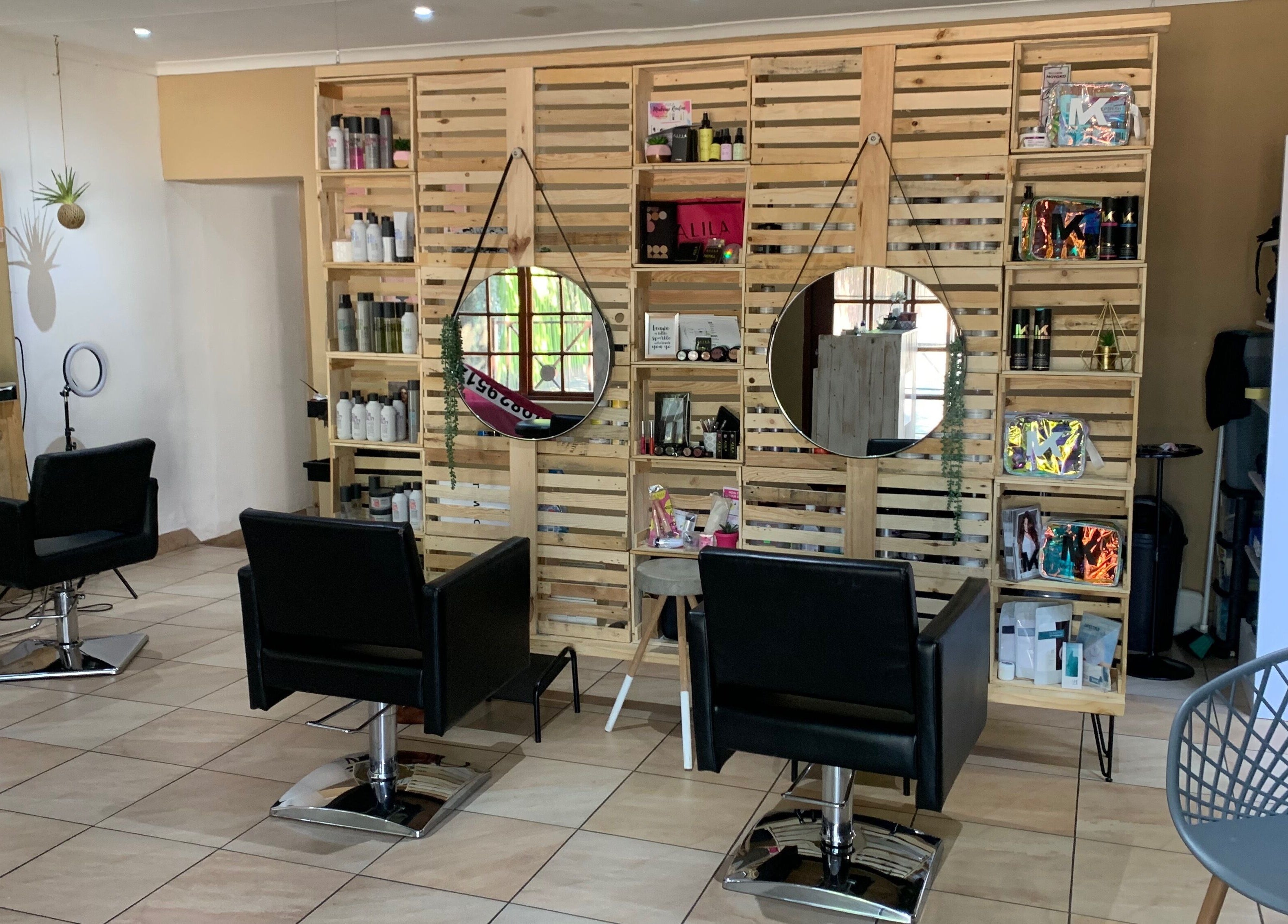 Elegant salon setup at Polished Pixie Hair Design, Benoni, Gauteng, ZA with modern chairs and stylish decor.