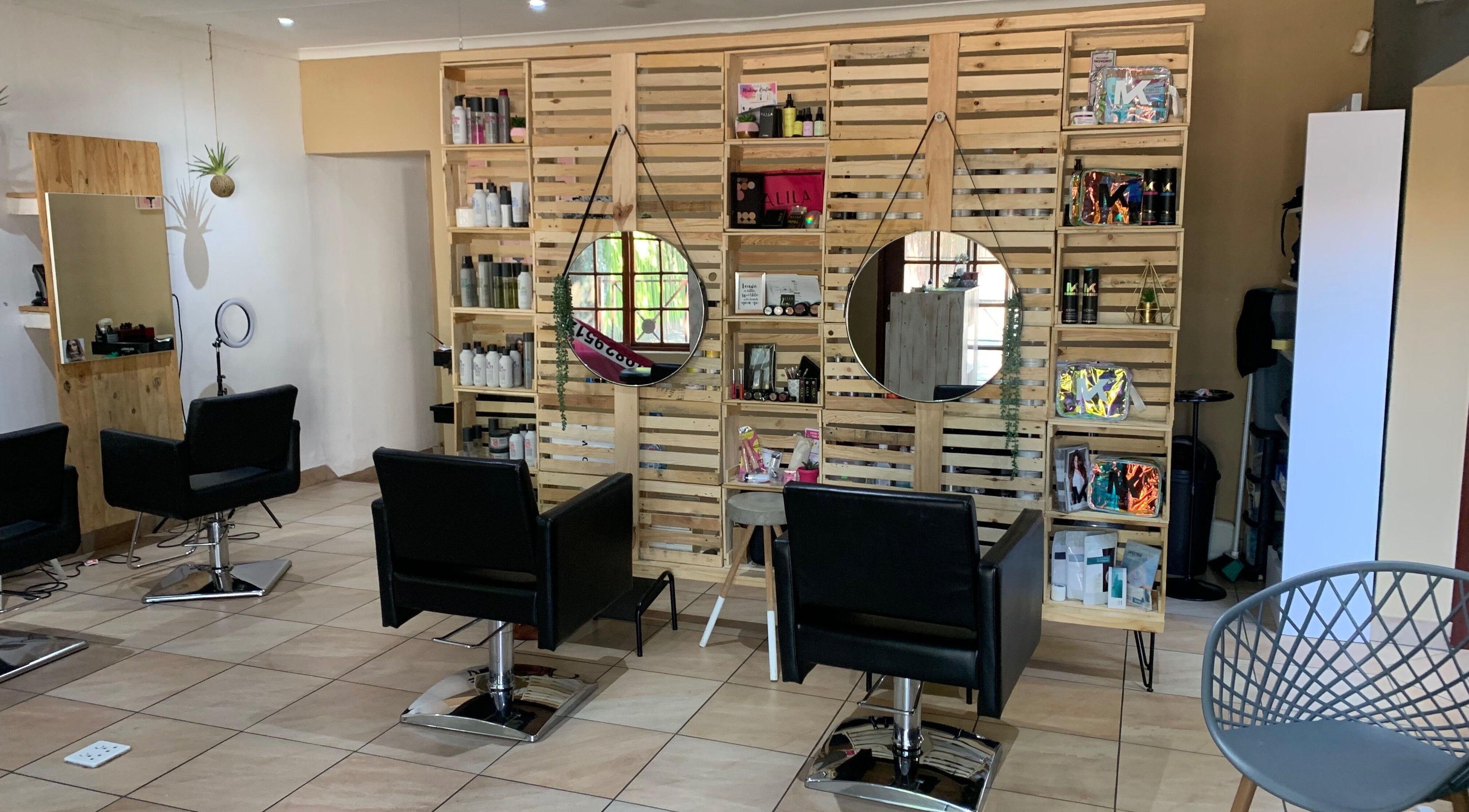 Elegant salon setup at Polished Pixie Hair Design, Benoni, Gauteng, ZA with modern chairs and stylish decor.