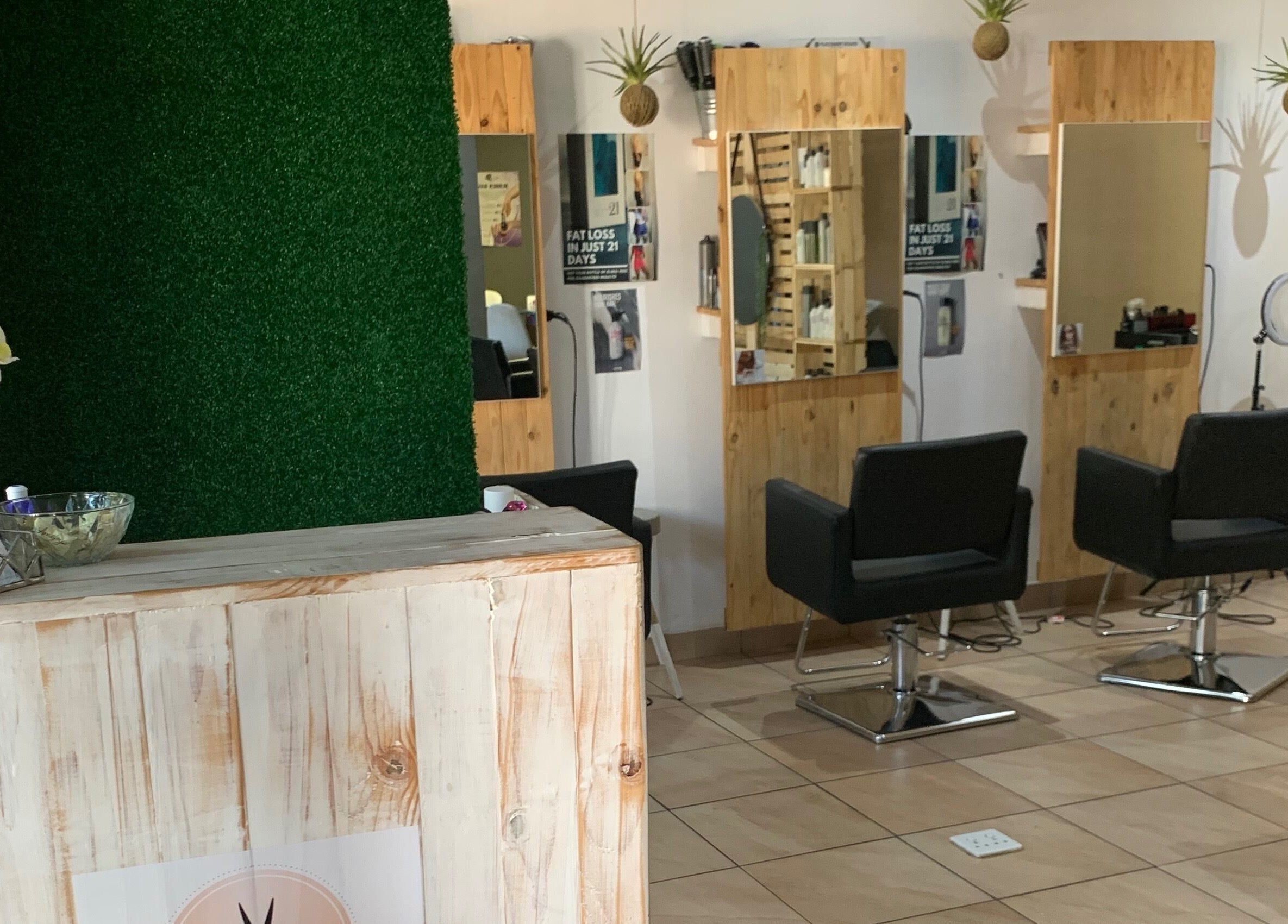 Chic salon interior of Polished Pixie Hair Design, Benoni, Gauteng, ZA with stylish chairs and wooden accents.