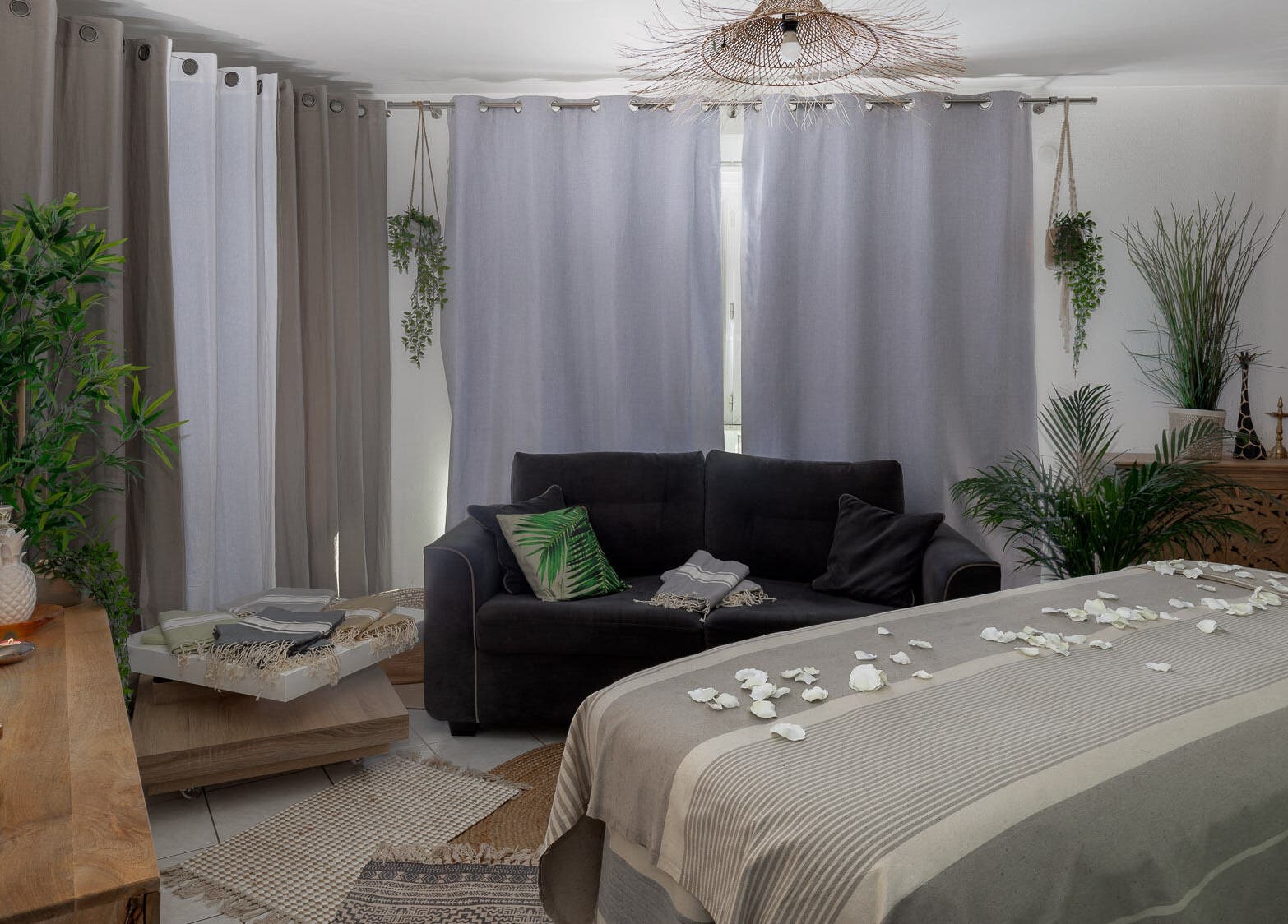 Salle de bien-être sereine à Pranaveda, Lyon, Auvergne-Rhône-Alpes, FR avec un canapé et des pétales blancs.