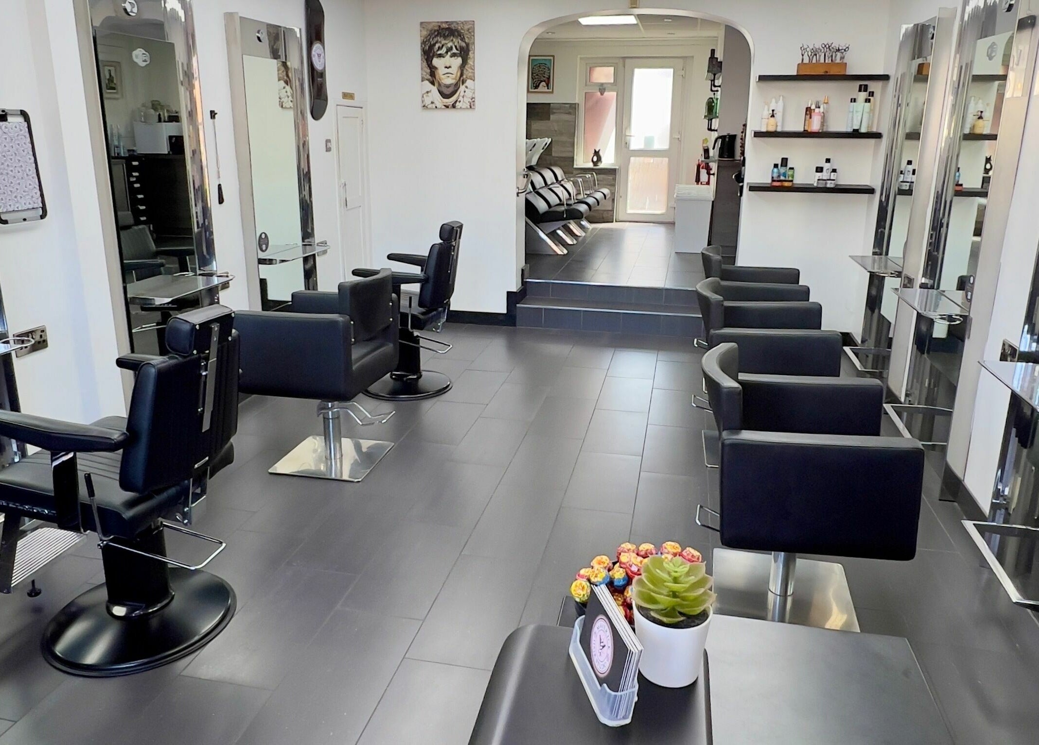 Modern interior of Maverick Hair Studio in Angmering, England, GB with sleek black chairs and styling stations.