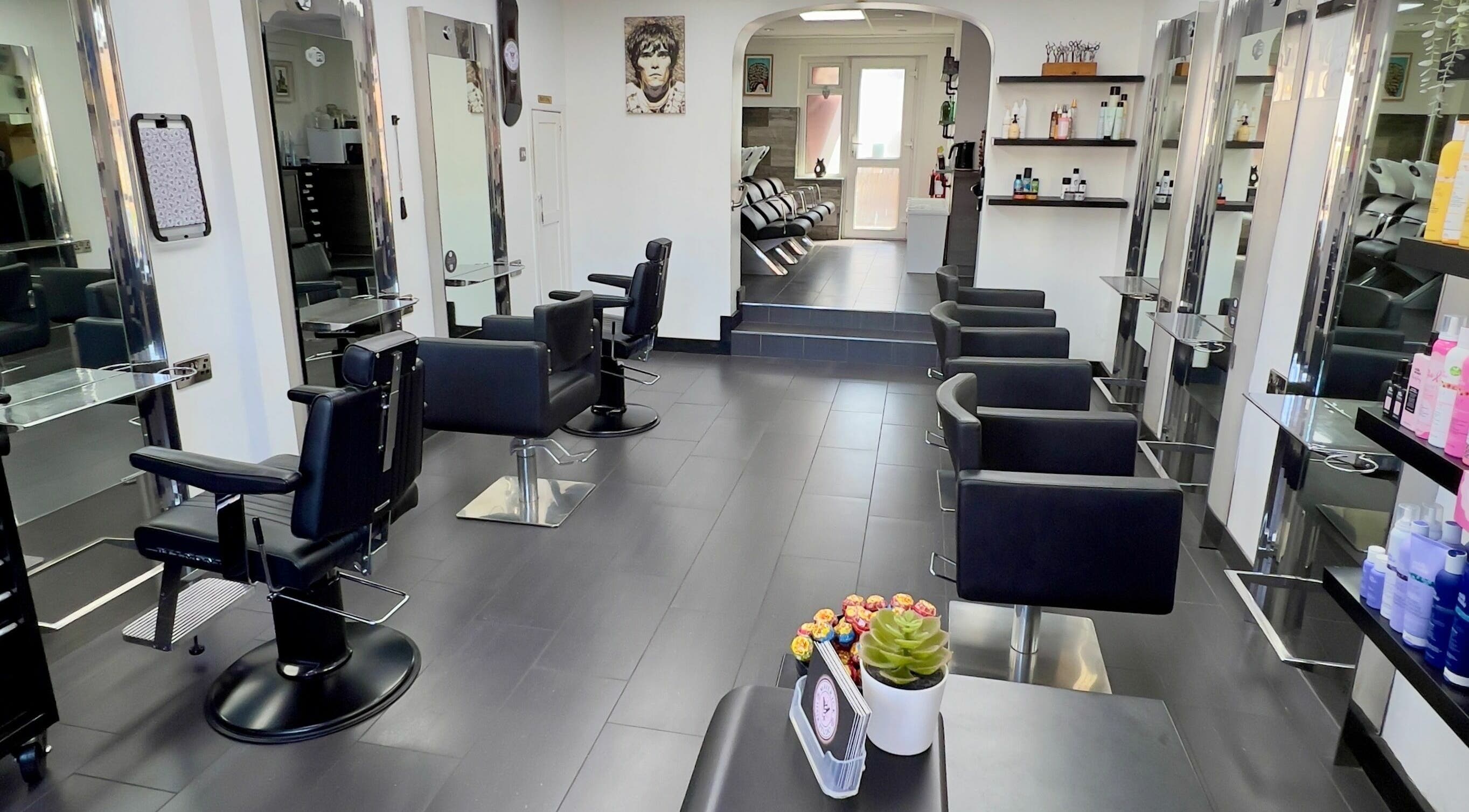 Modern interior of Maverick Hair Studio in Angmering, England, GB with sleek black chairs and styling stations.