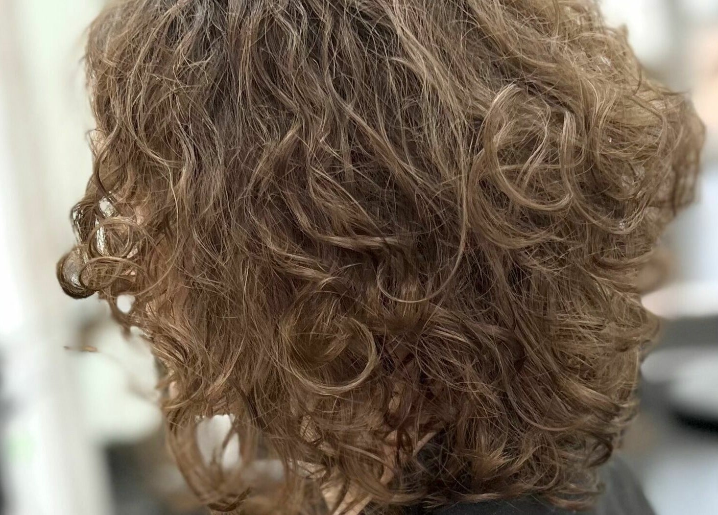Curly hairstyle at Maverick Hair Studio in Angmering, England, GB. Showcasing expert styling techniques.