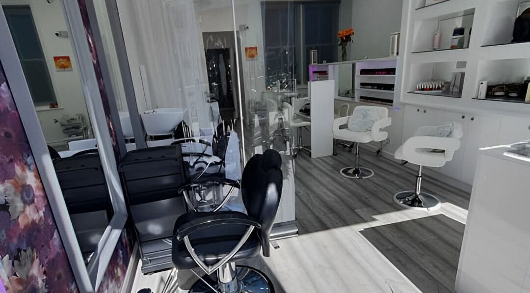 Modern salon interior at Lavish Beauty Clinic in London, England, GB with sleek styling chairs and vibrant decor.