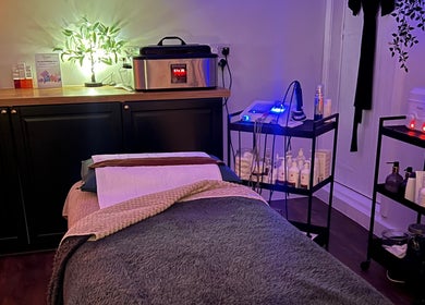 Relaxing treatment room at Samantha Joyce Beauty, Basingstoke, England, GB, with massage table and soft lighting.