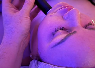 Facial treatment at Samantha Joyce Beauty, Basingstoke, England, GB under calming purple light.