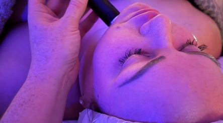Facial treatment at Samantha Joyce Beauty, Basingstoke, England, GB under calming purple light.