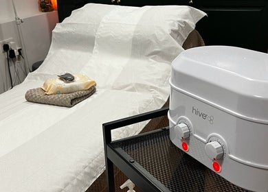 Relaxing treatment room at Samantha Joyce Beauty in Basingstoke, England featuring a comfortable spa bed with warming unit.