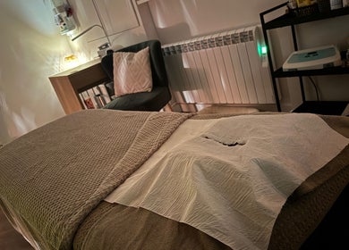 Cozy treatment room at Samantha Joyce Beauty, Basingstoke, England, GB, with massage bed and ambient lighting.