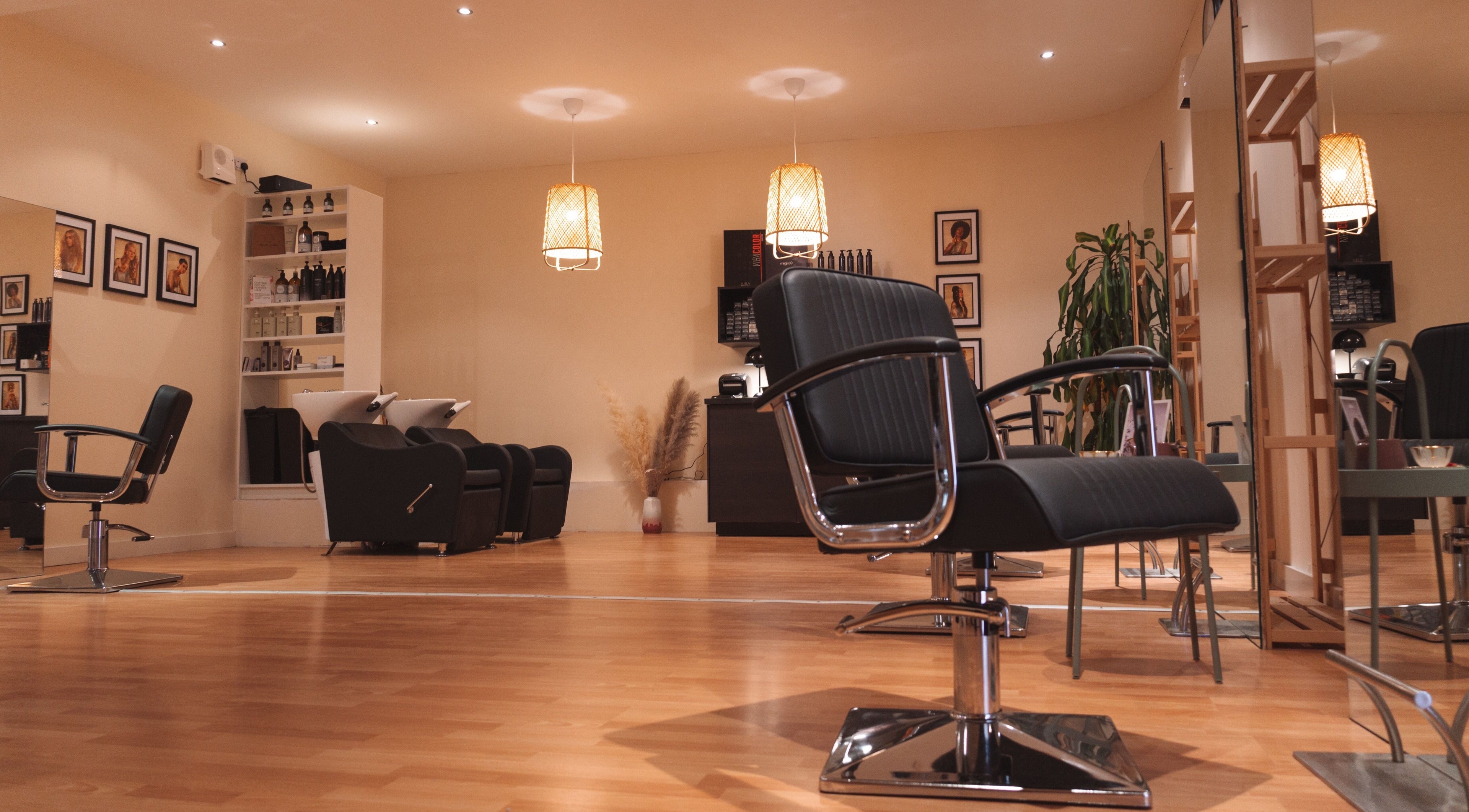Elegant salon interior at La Bohème Hub, Lisburn, Northern Ireland, GB featuring chic styling chairs and ambient lighting.