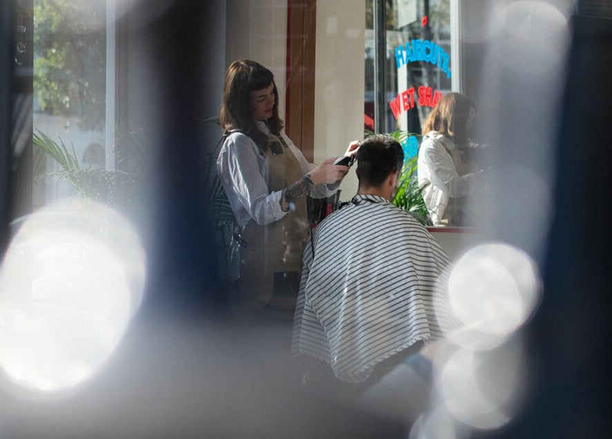 Haircut service at ELP Barbershop in London, England, GB. A barber styling a client's hair.