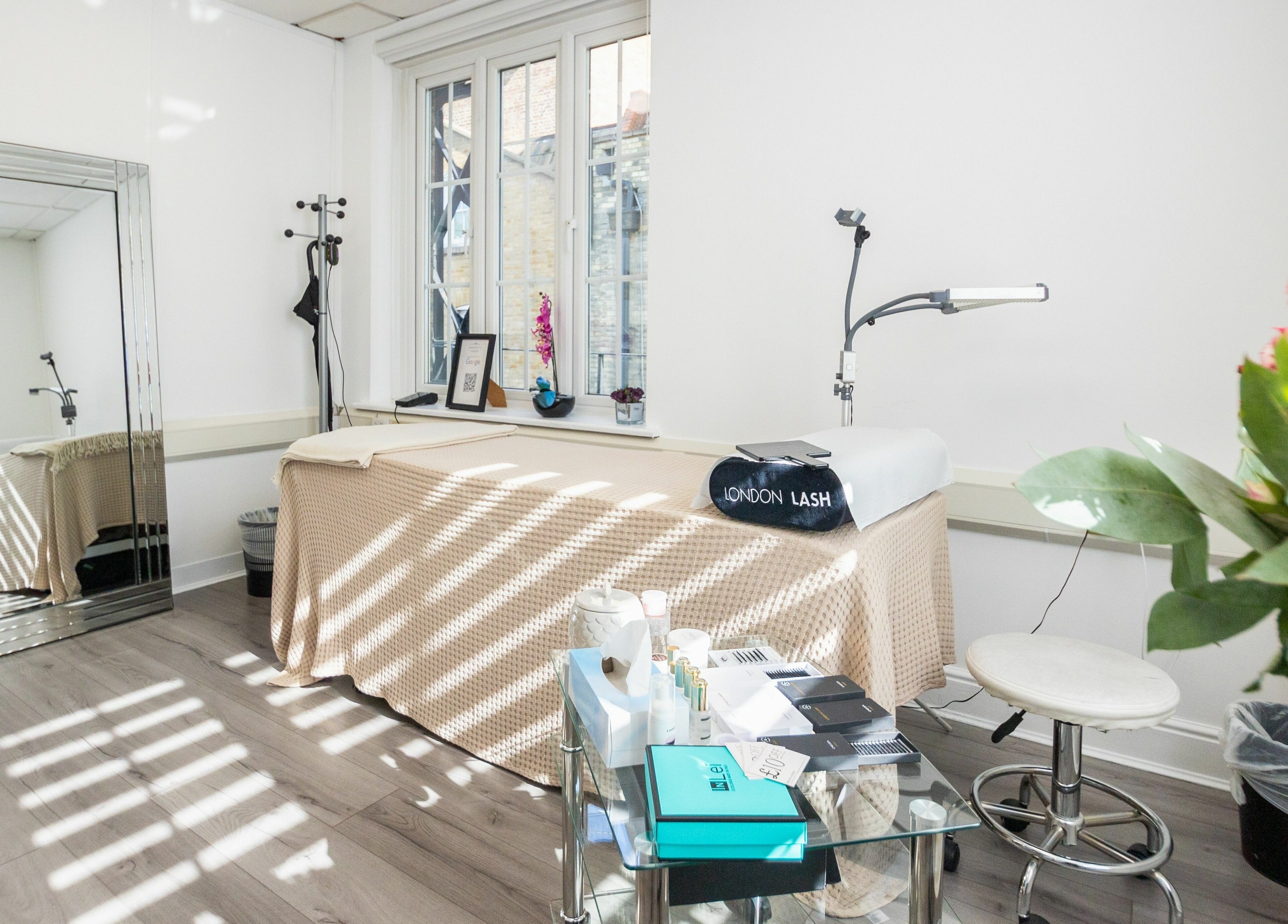 Elegant lash treatment room at Lashes In Style, London, England, GB, featuring comfortable bed and decor.