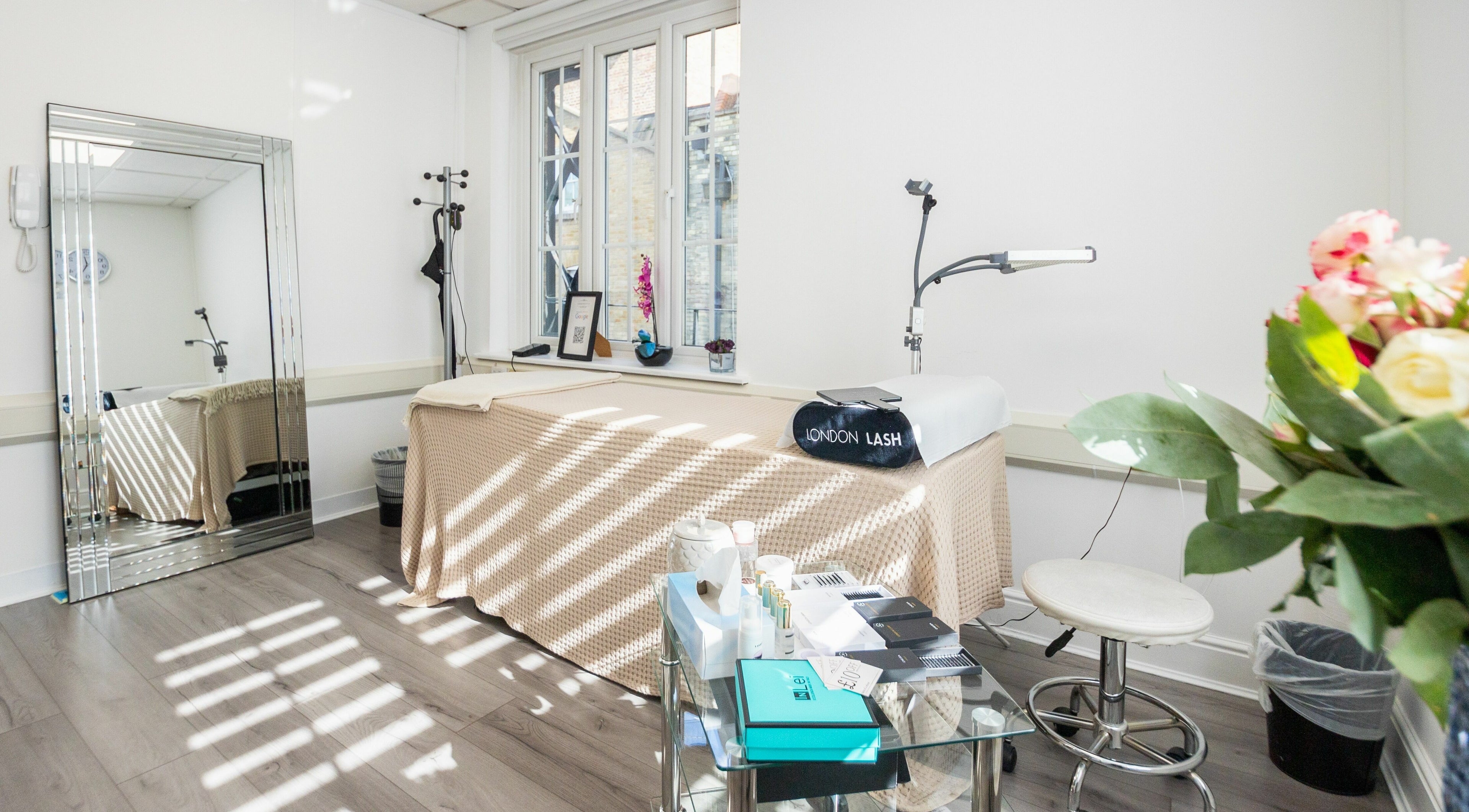 Elegant lash treatment room at Lashes In Style, London, England, GB, featuring comfortable bed and decor.