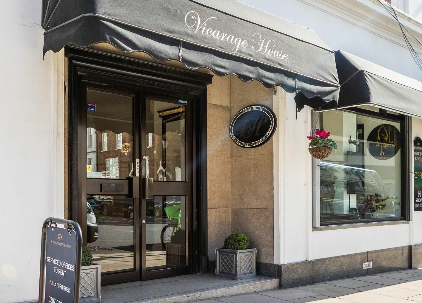 Elegant entrance of Lashes In Style at Vicarage House, London, England, GB with black awning and glass doors.