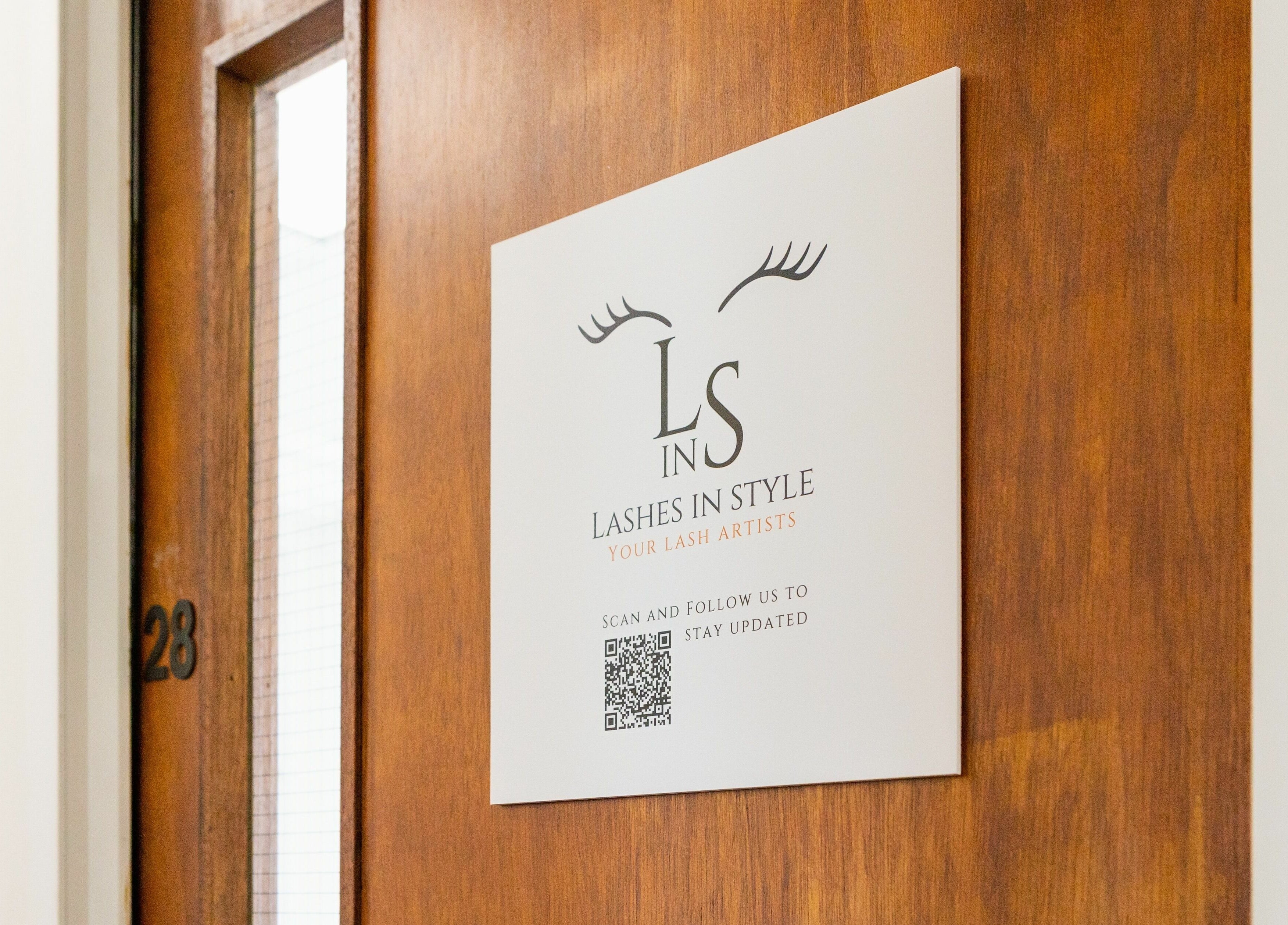Signage for Lashes In Style on a wooden door in London, England, GB.